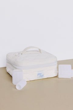 A white quilted square Hair Roller Set Pearl carrying case with a top handle and lace trim, displayed with three velcro rollers for a bridal blowout.